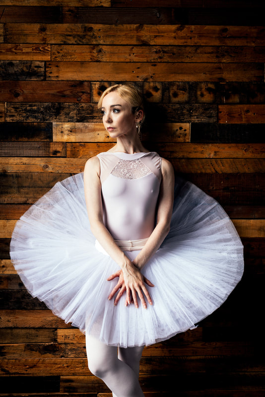 Graceful ballerina Emily Joy, adorned in a stunning dance ensemble, captivates with her elegant movements and artistic expression